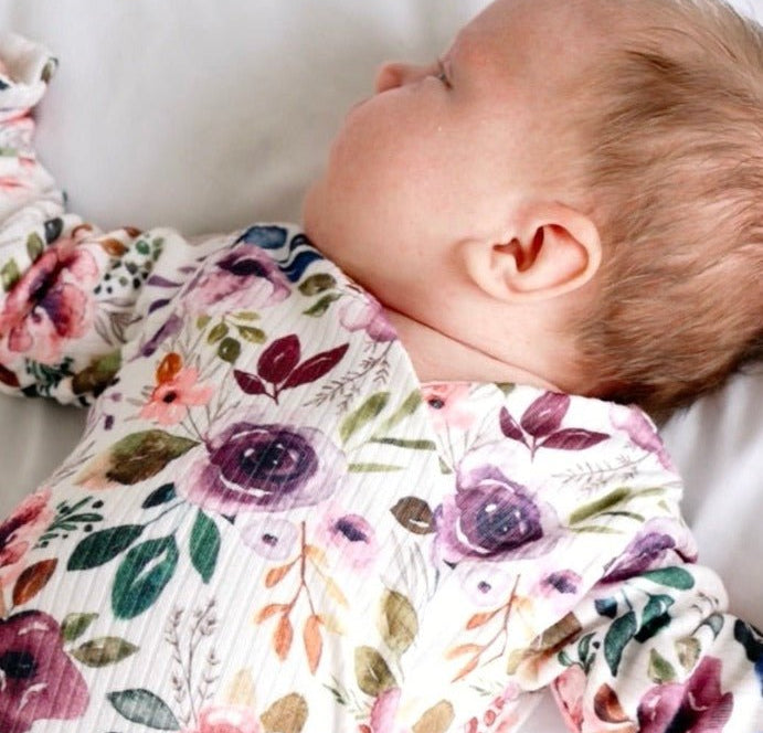 Reversible ruffle cuff baby bodysuit with wings in Ivory Wildflowers design, classic brushed fabric for babies.