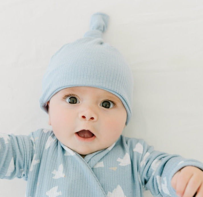 Newborn wearing Mama Coco bamboo baby beanie in cornflour doves blue design in brushed viscose fabric.