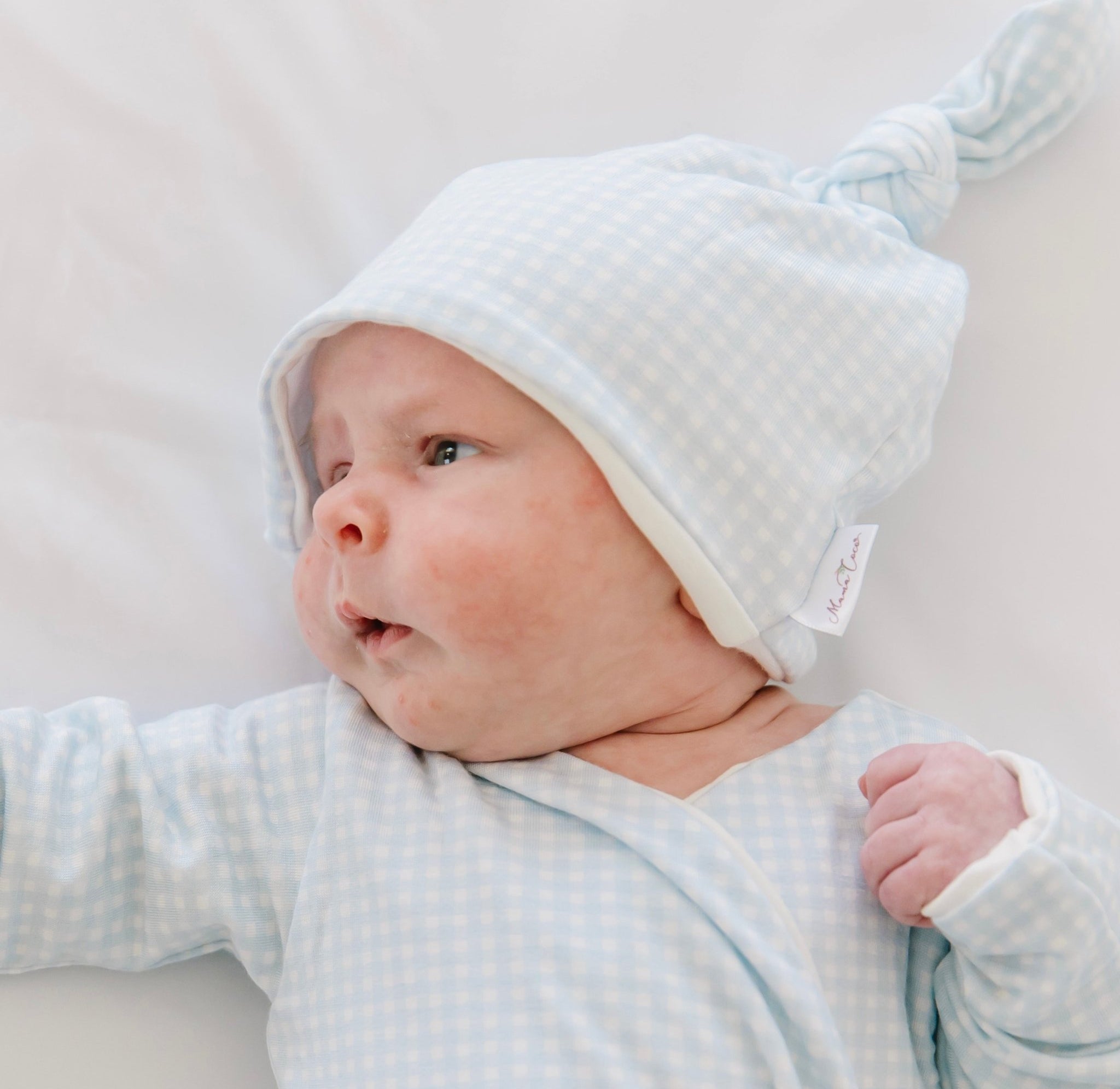 Newborn wearing Mama Coco bamboo baby beanie in plush perfection design.