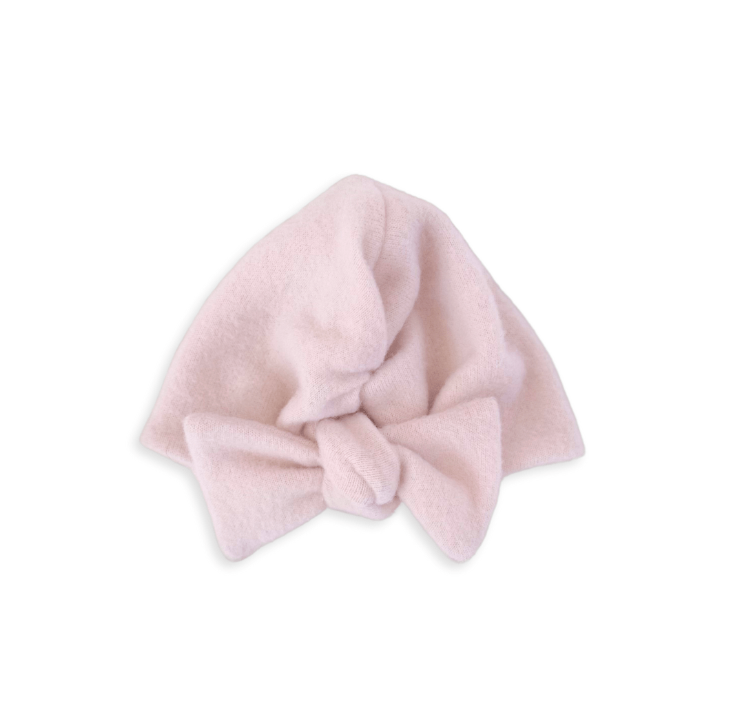 Ruched beanie with bow in plush pink cashmere design in plush dreams fabric.