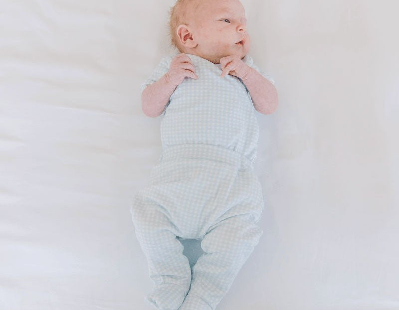 Baby footie pants crafted from soft silky modal fabric featuring the Baby Blue Gingham design.