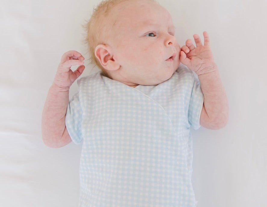 Baby blue gingham design short-sleeve baby onesie in silky modal fabric.