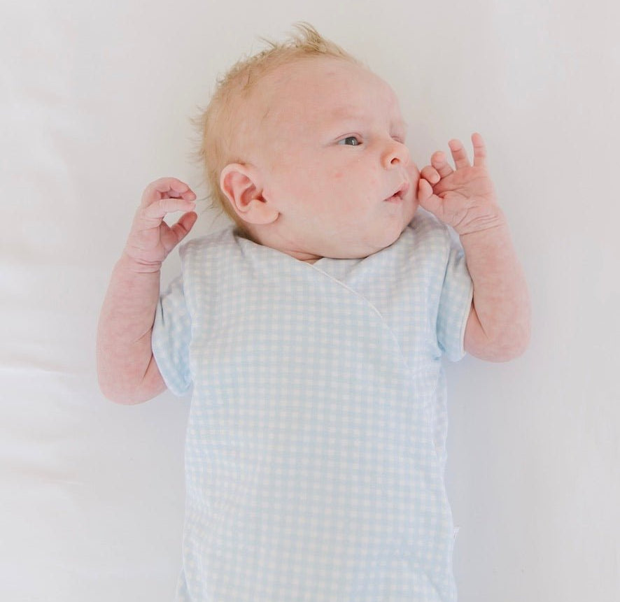 Baby blue gingham design short-sleeve baby onesie in silky modal fabric.