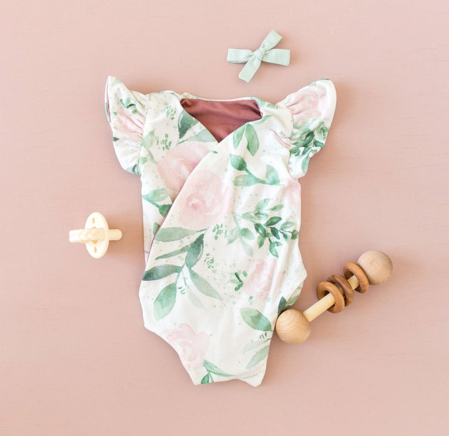 Blushing Eucalyptus baby bodysuit with short sleeves in soft Classic Brushed fabric styles.