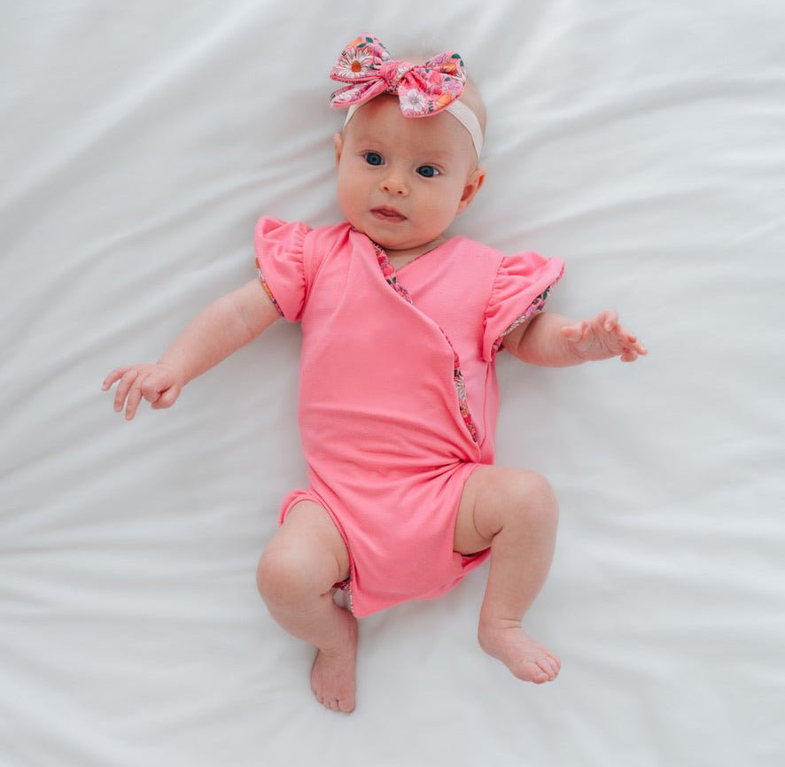Reversible Flower Power print baby bodysuit crafted in Classic Brushed fabric styles.