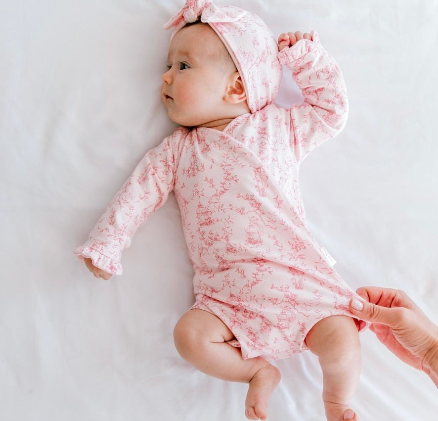 Whimsical garden newborn baby clothing bundle in classic brushed fabric with long sleeve ruffle cuff detail.