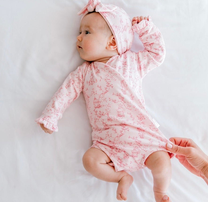 Whimsical garden newborn baby clothing bundle in classic brushed fabric with long sleeve ruffle cuff detail.