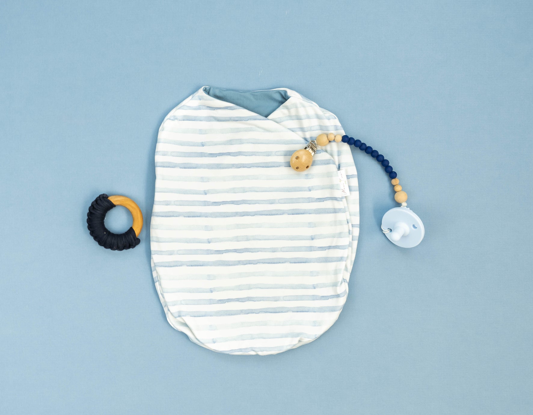 Baby cocoon swaddle featuring our chambray waves design, made from classic brushed fabric.