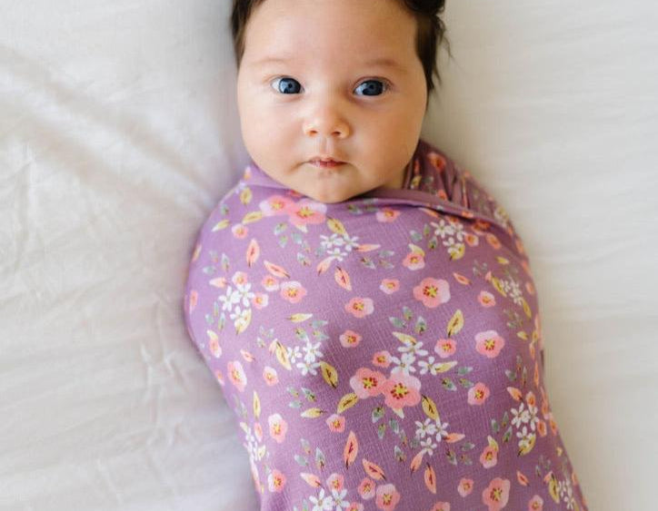 Baby cocoon swaddle featuring our peachy lilac design, made from classic brushed fabric.