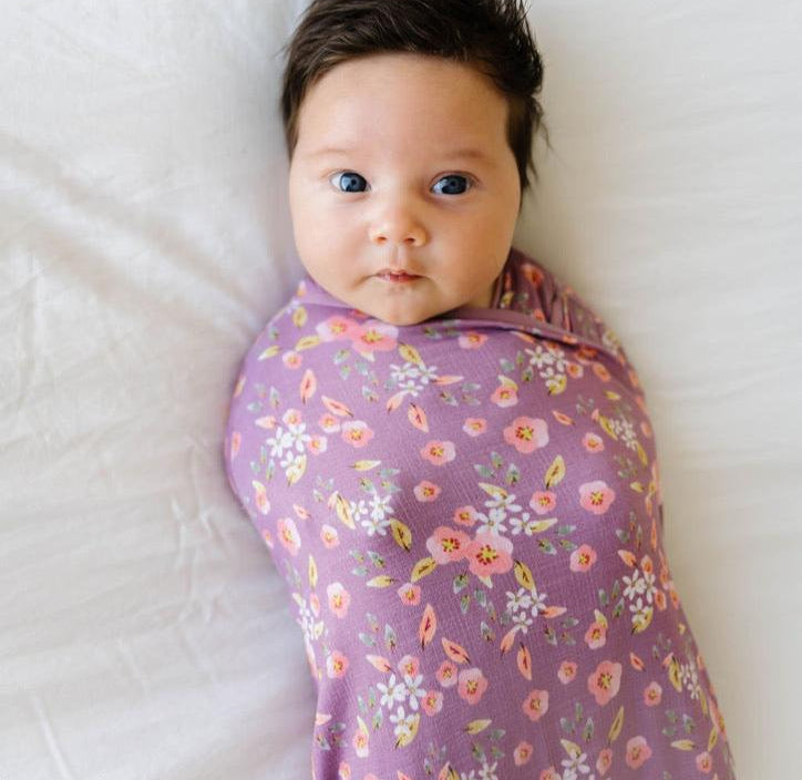 Baby cocoon swaddle featuring our peachy lilac design, made from classic brushed fabric.