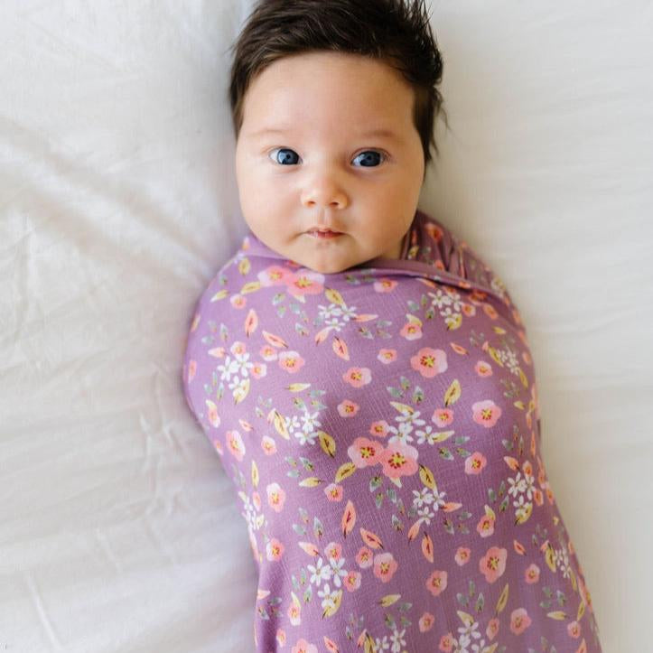 Baby cocoon swaddle featuring our peachy lilac design, made from classic brushed fabric.