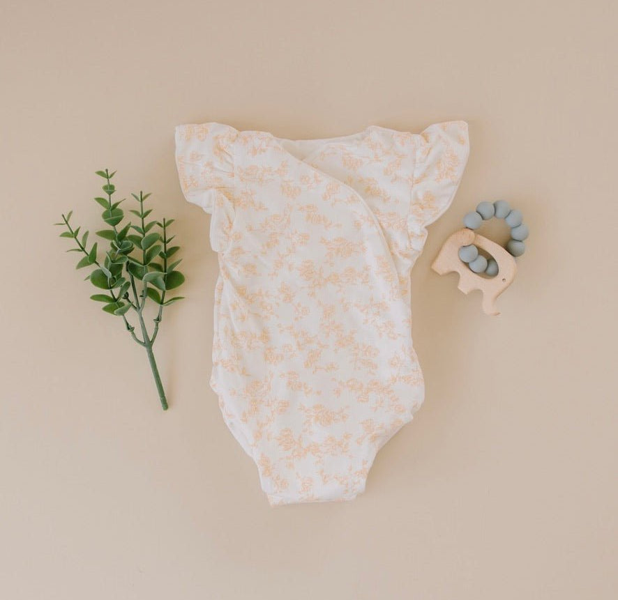 Baby flutter sleeve onesie made from silky modal fabric in Bitty Blooms design.