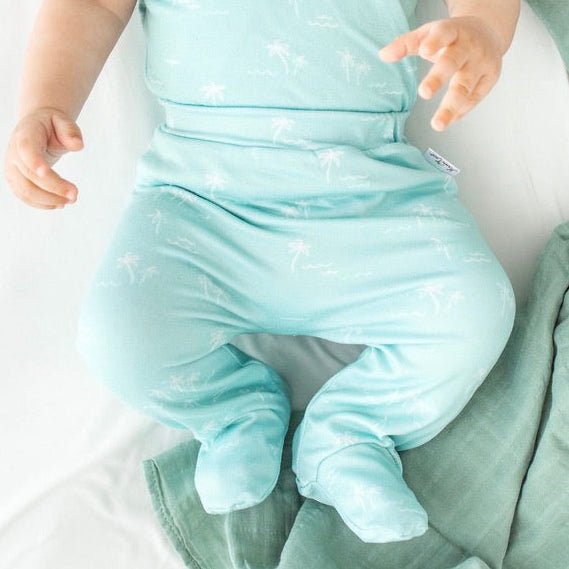 Soft and gentle baby footie pants made from bamboo cotton fabric in the Honeydew Palms design.