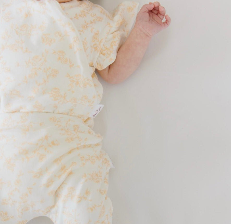 Baby footie pants in bitty blooms design.