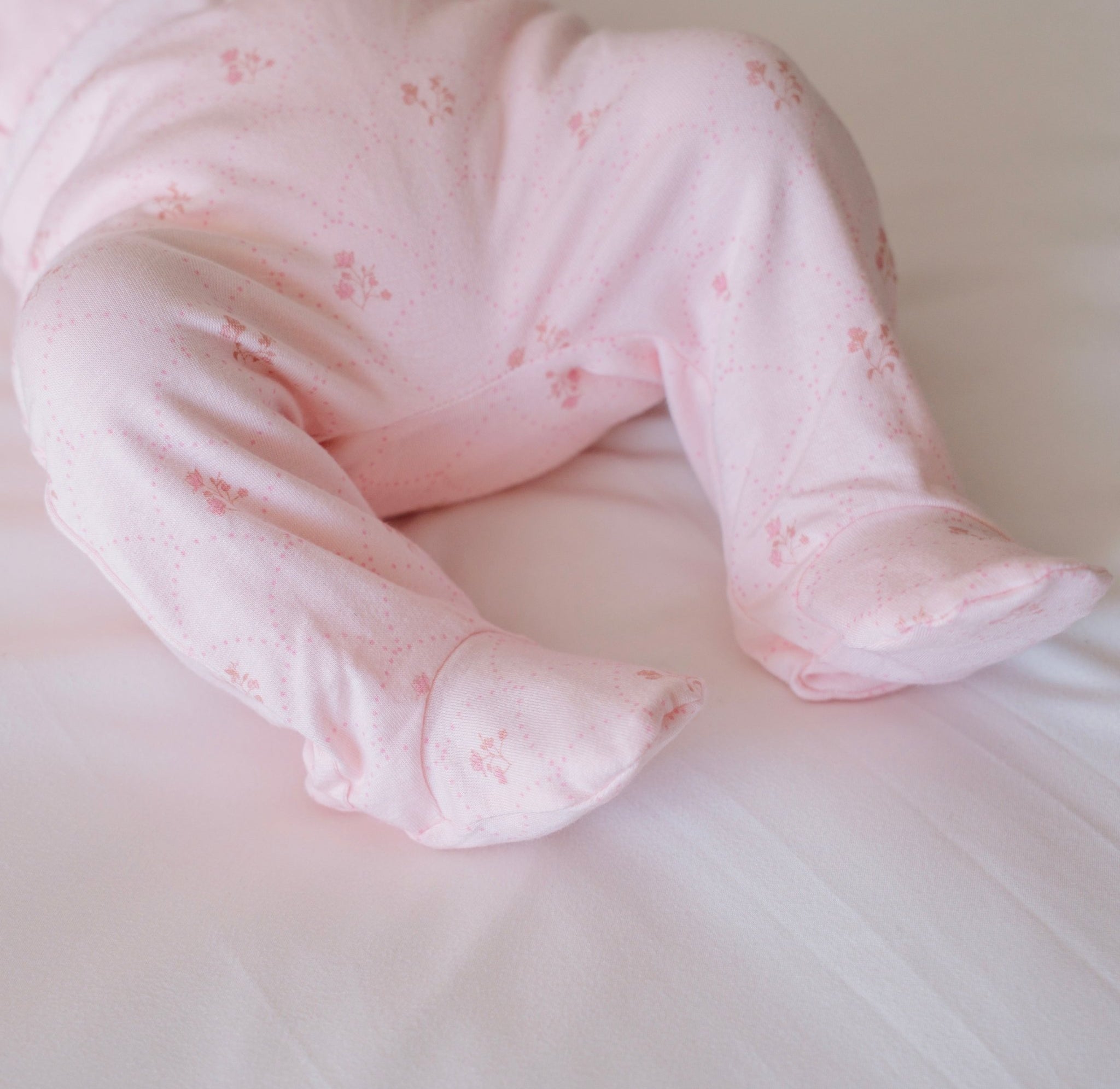 Baby footie pants in dainty dots design.