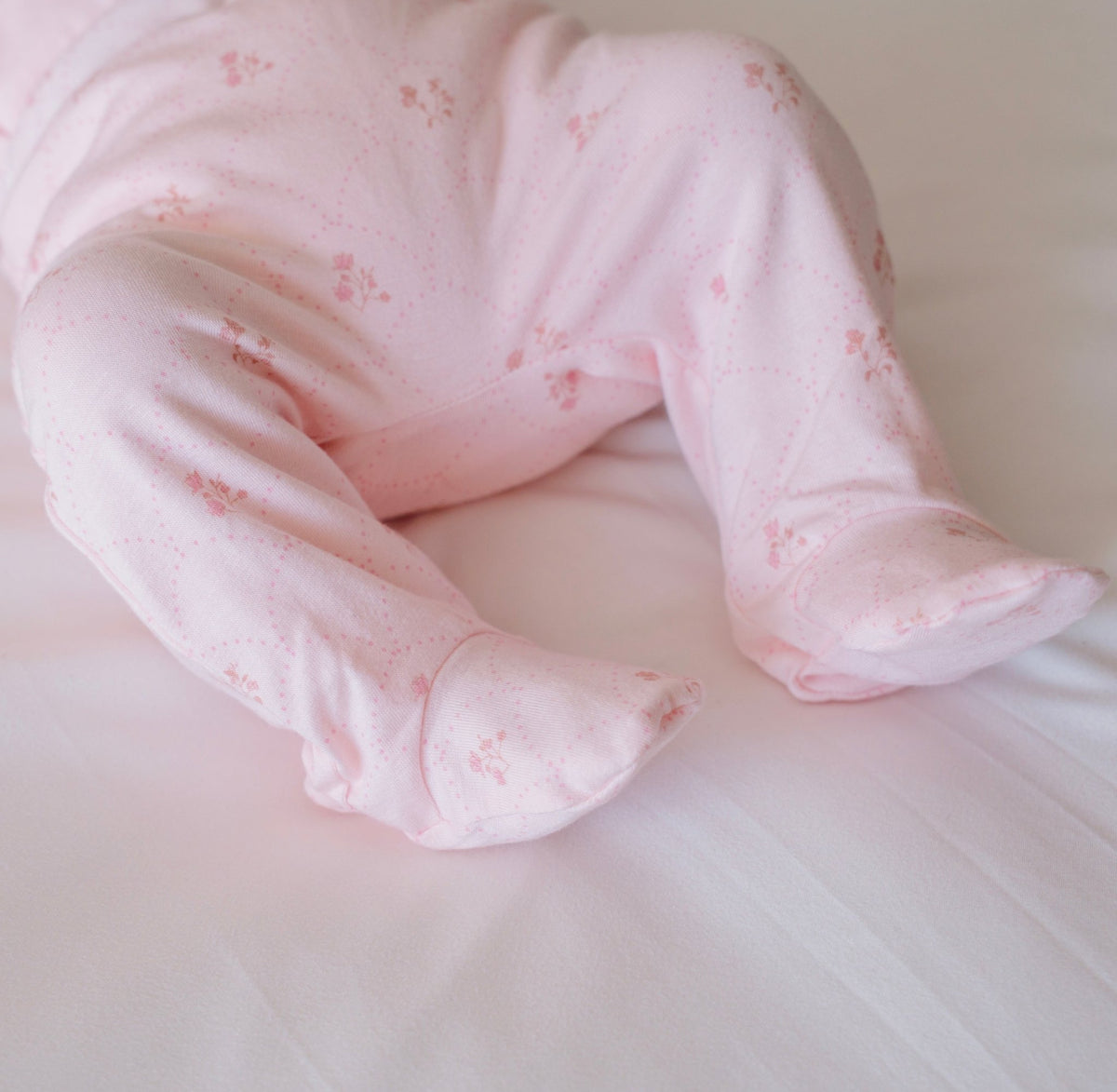 Baby footie pants in dainty dots design.