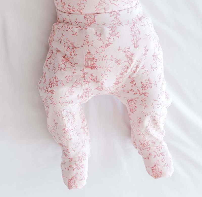 Baby footie pants in whimsical garden design.