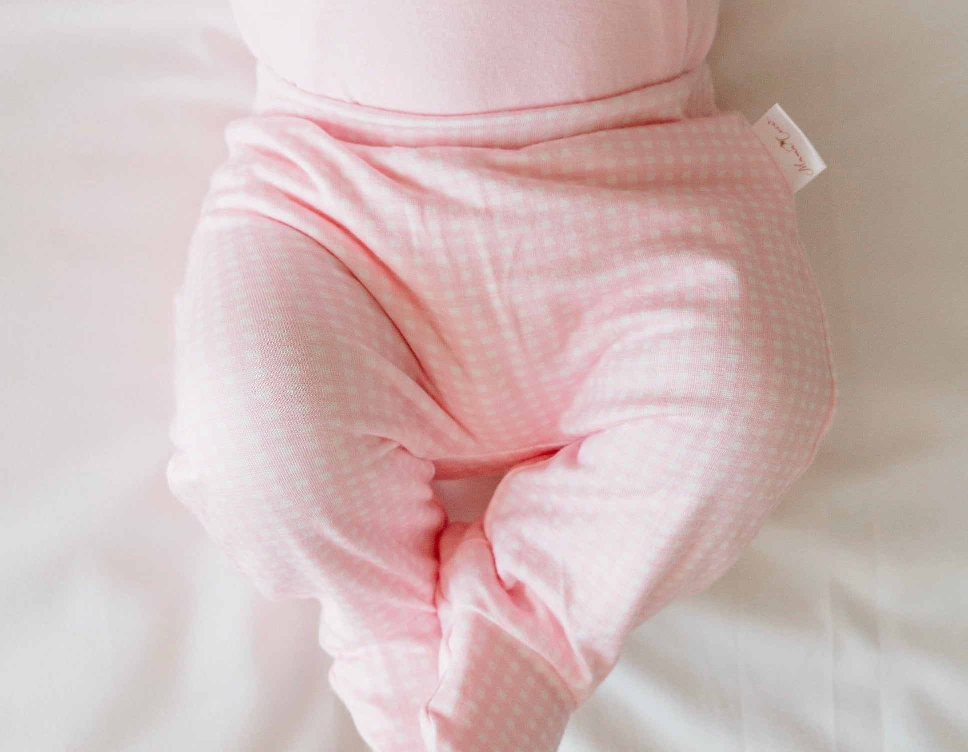 Baby Pink Gingham baby footie pants crafted from silky modal fabric for maximum comfort.
