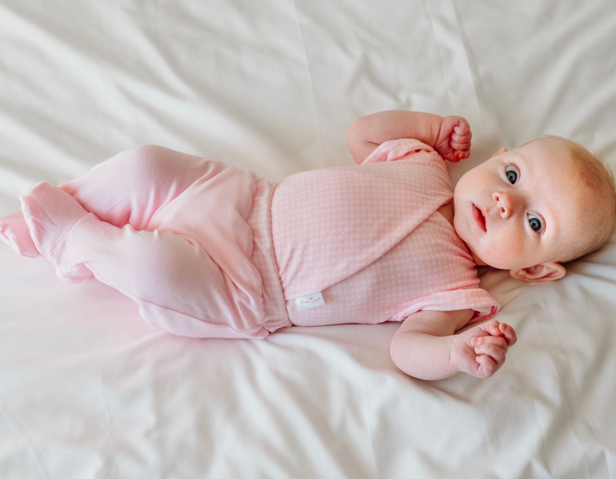 Cozy baby footie pants in silky modal fabric with an adorable Baby Pink Gingham pattern.