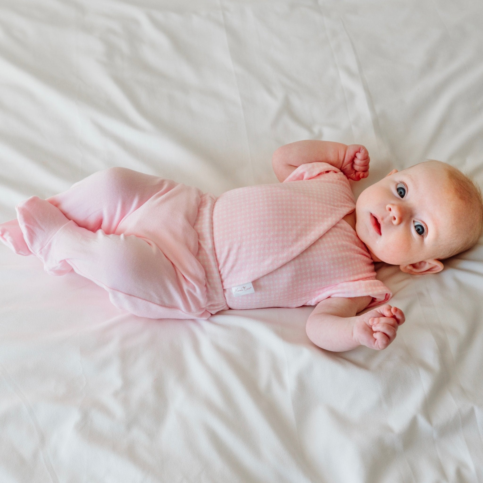 Cozy baby footie pants in silky modal fabric with an adorable Baby Pink Gingham pattern.