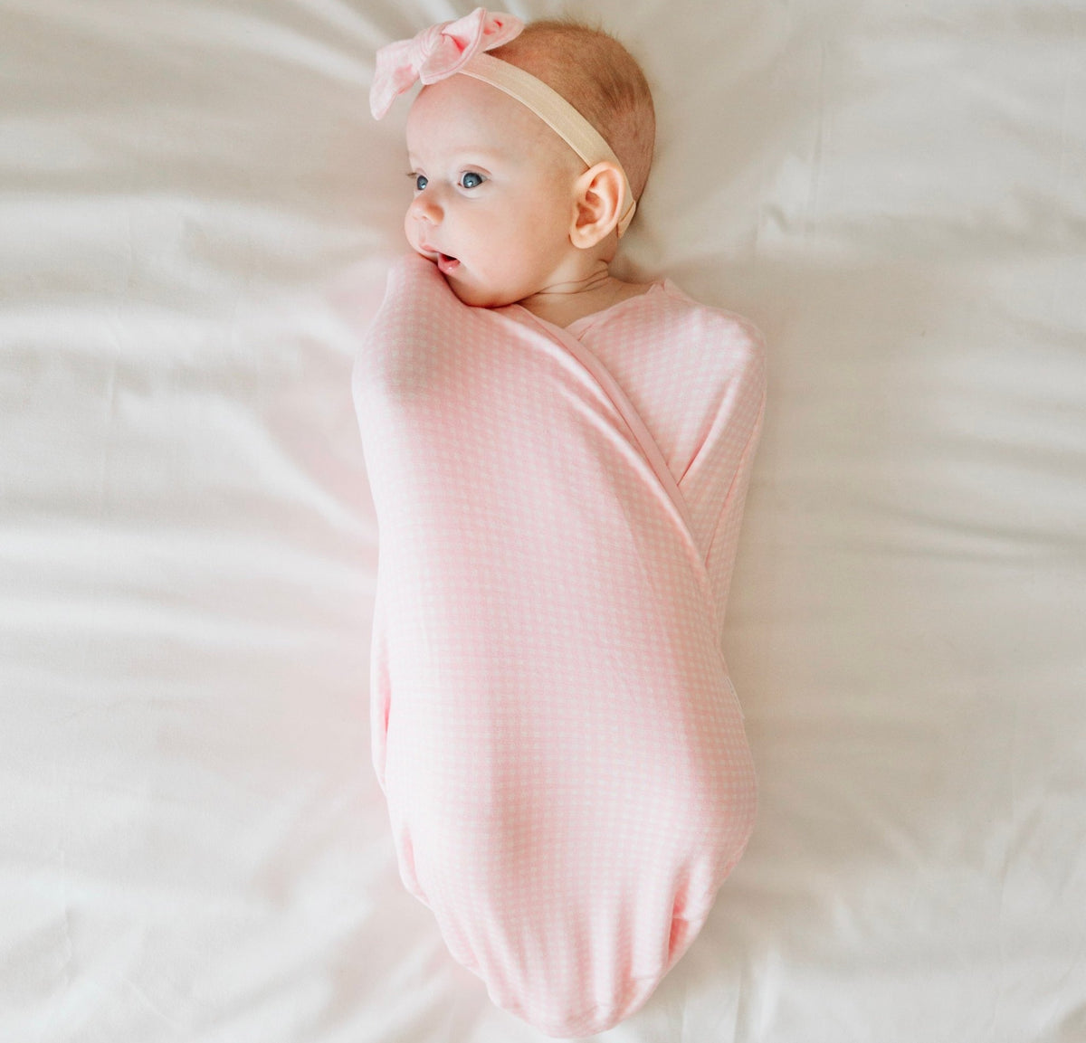 Baby Pink Gingham Cocoon swaddle baby blanket in Silky Modal fabric styles. Soft and cozy newborn wrap blanket.