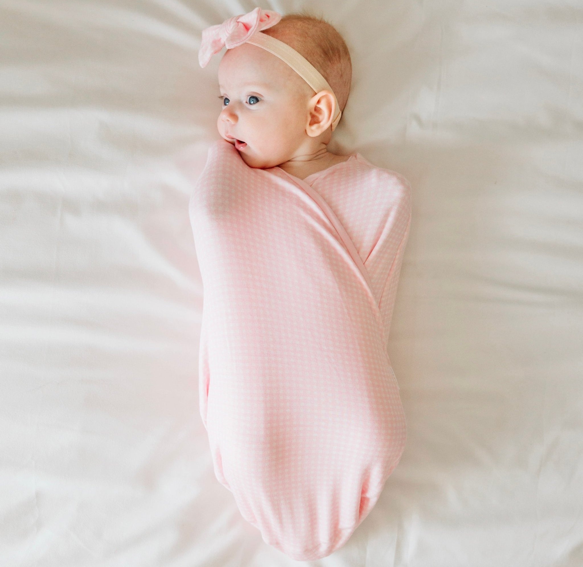Baby Pink Gingham Cocoon swaddle baby blanket in Silky Modal fabric styles. Soft and cozy newborn wrap blanket.