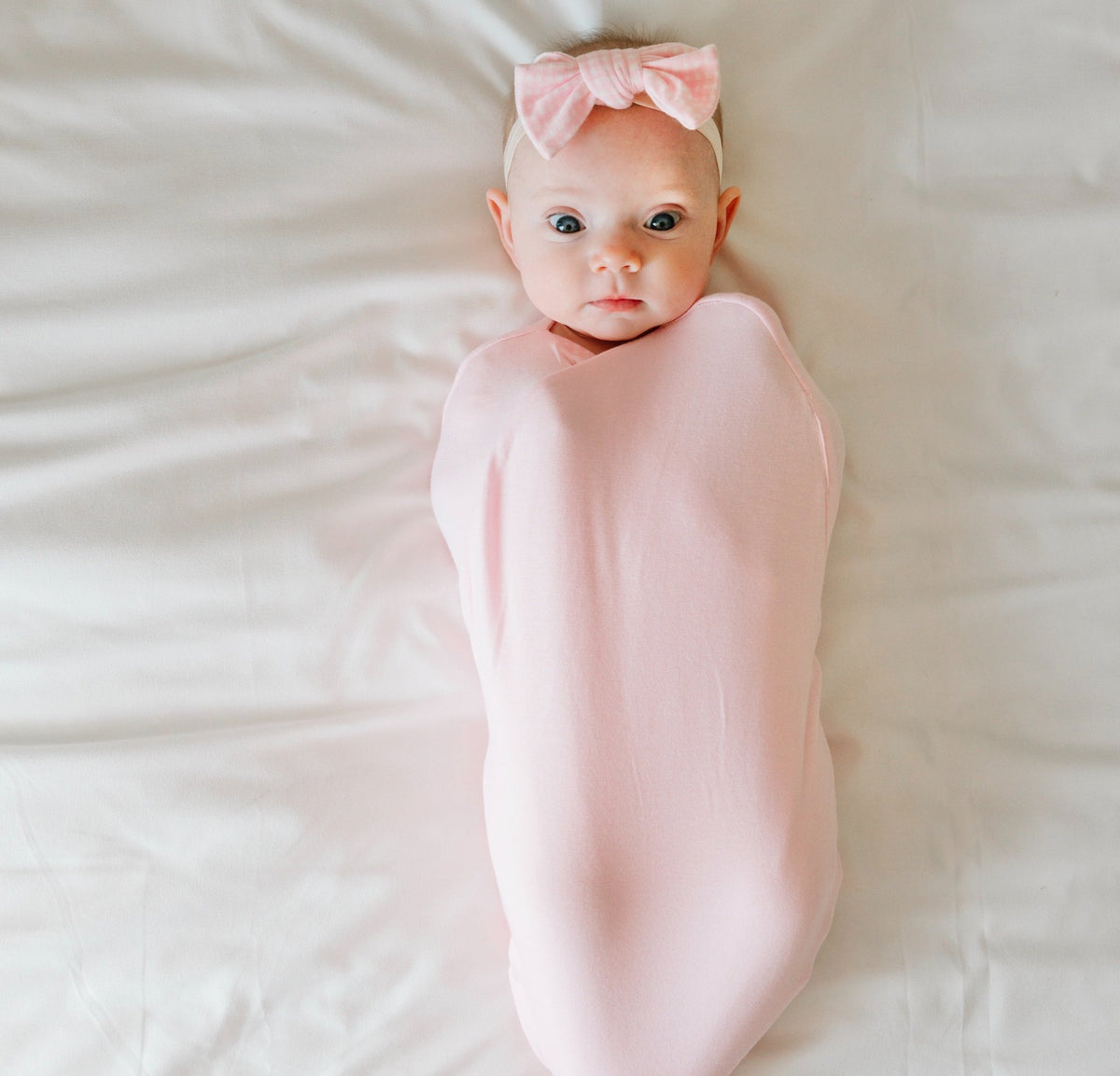 Newborn comfort meets Baby Pink Gingham in this Cocoon swaddle blanket in Silky Modal fabric styles.