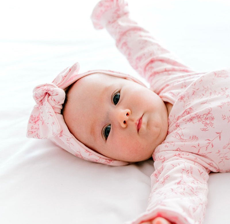 Bamboo cotton baby ruched bow beanie in whimsical garden design.