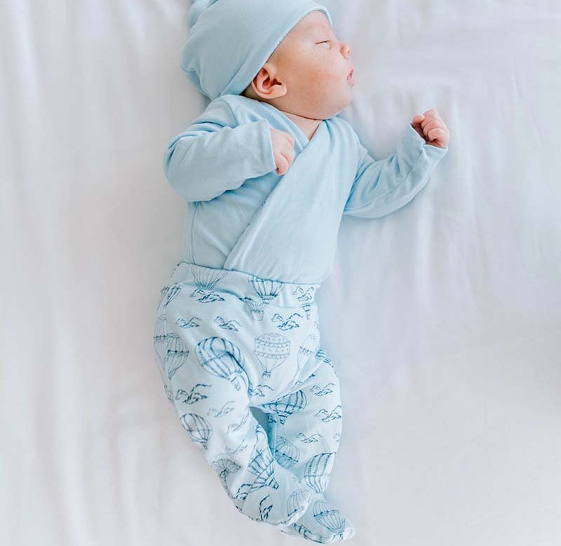 Cozy baby footie pants crafted from bamboo cotton in the bon voyage design.