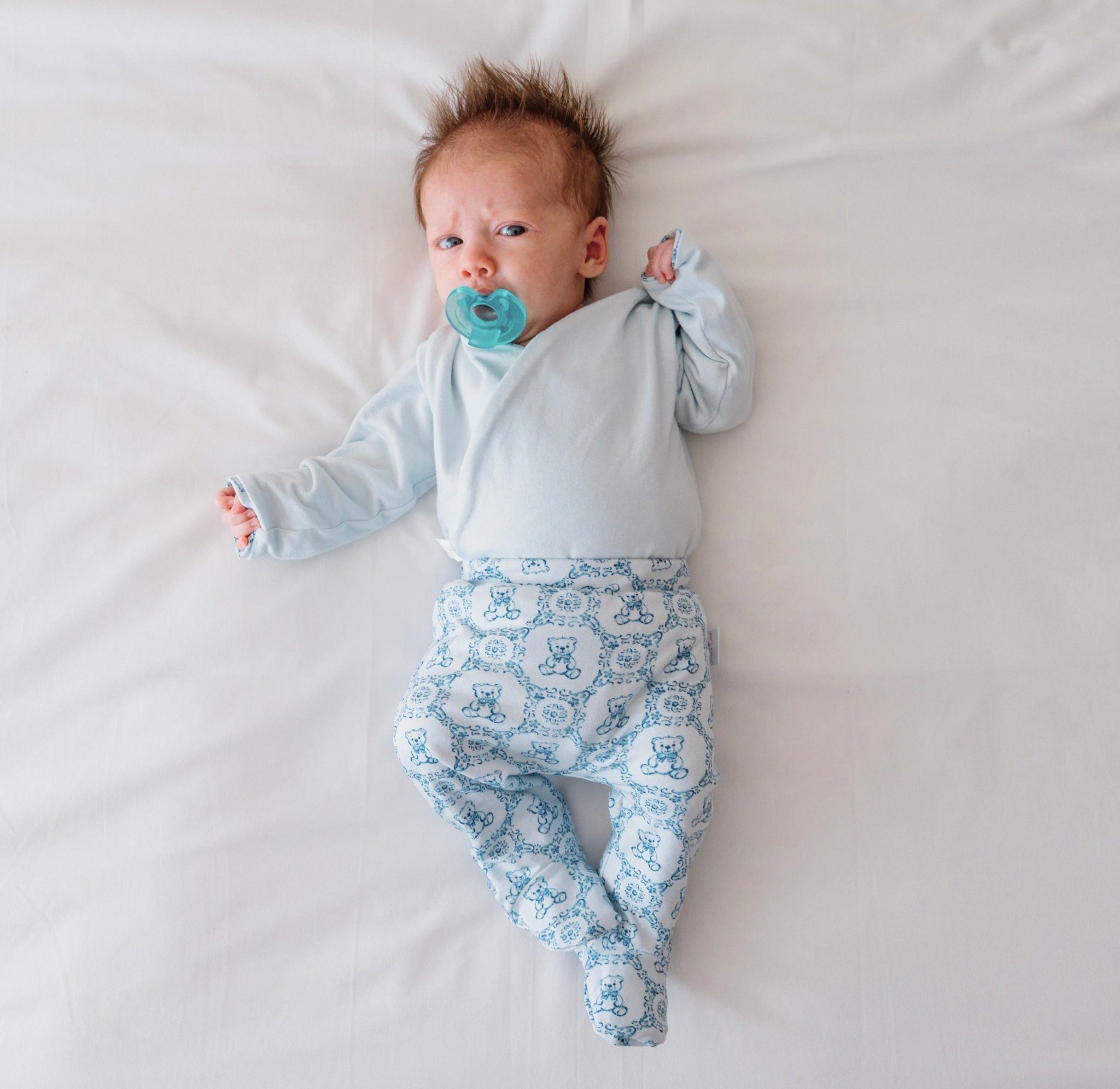 Premium baby footie pants made from bamboo cotton fabric in Teddy Tiles print.