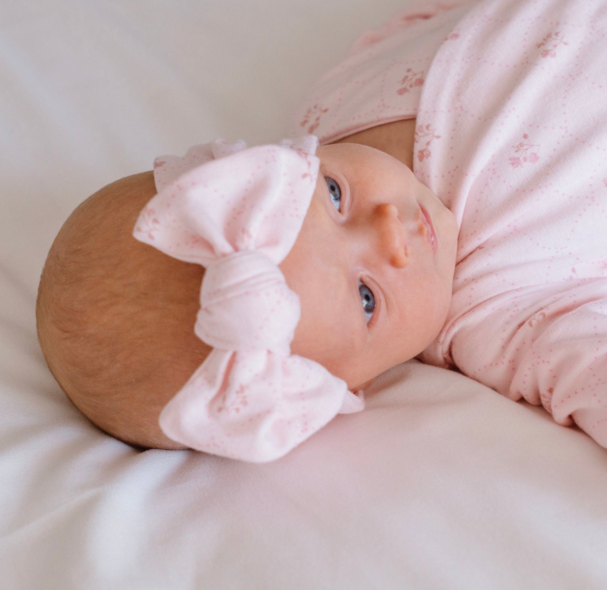 Baby headwrap with bow, made from bamboo and organic cotton fabric in a dainty dots design.