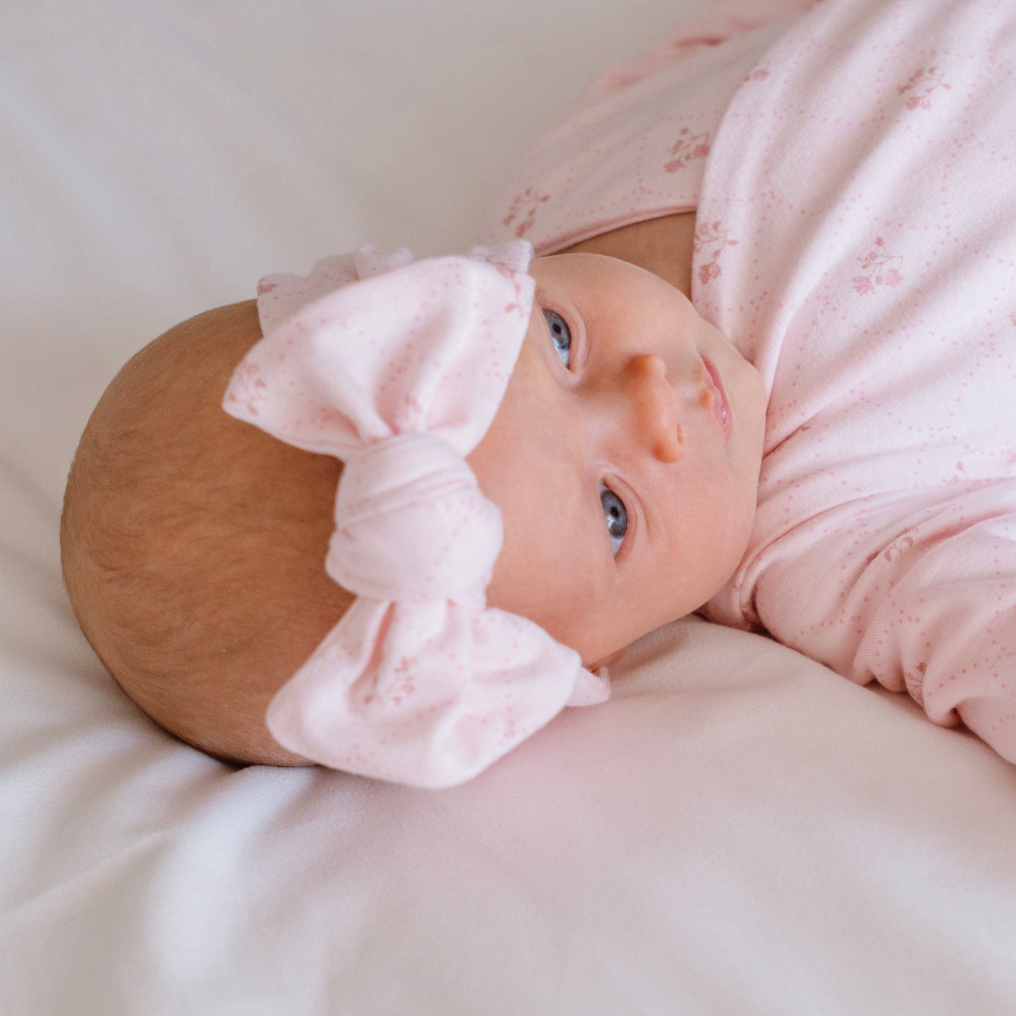 Baby headwrap with bow, made from bamboo and organic cotton fabric in a dainty dots design.