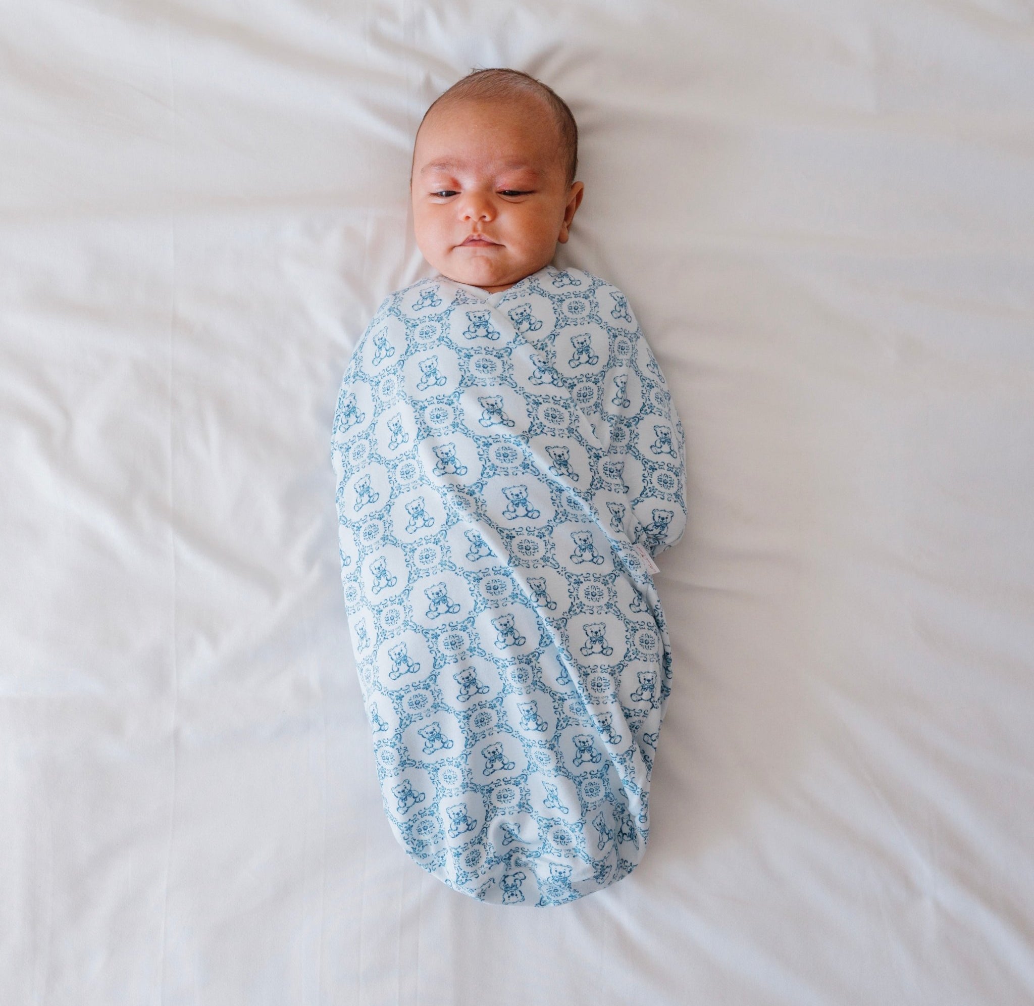 Organic cotton and bamboo baby swaddle cocoon blanket featuring a charming Teddy Tiles design.