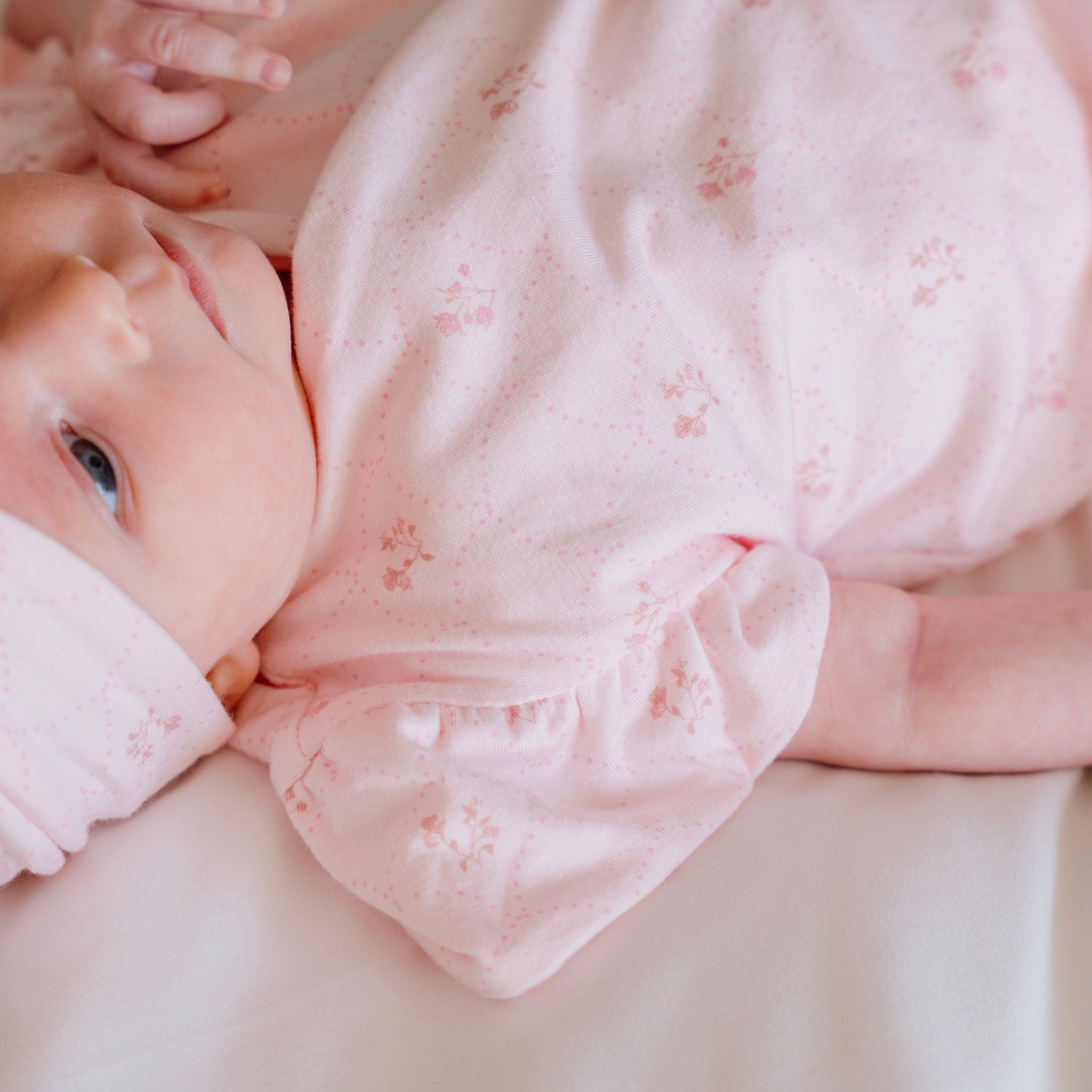 Flutter sleeve winged bodysuit for babies in dainty dots design.