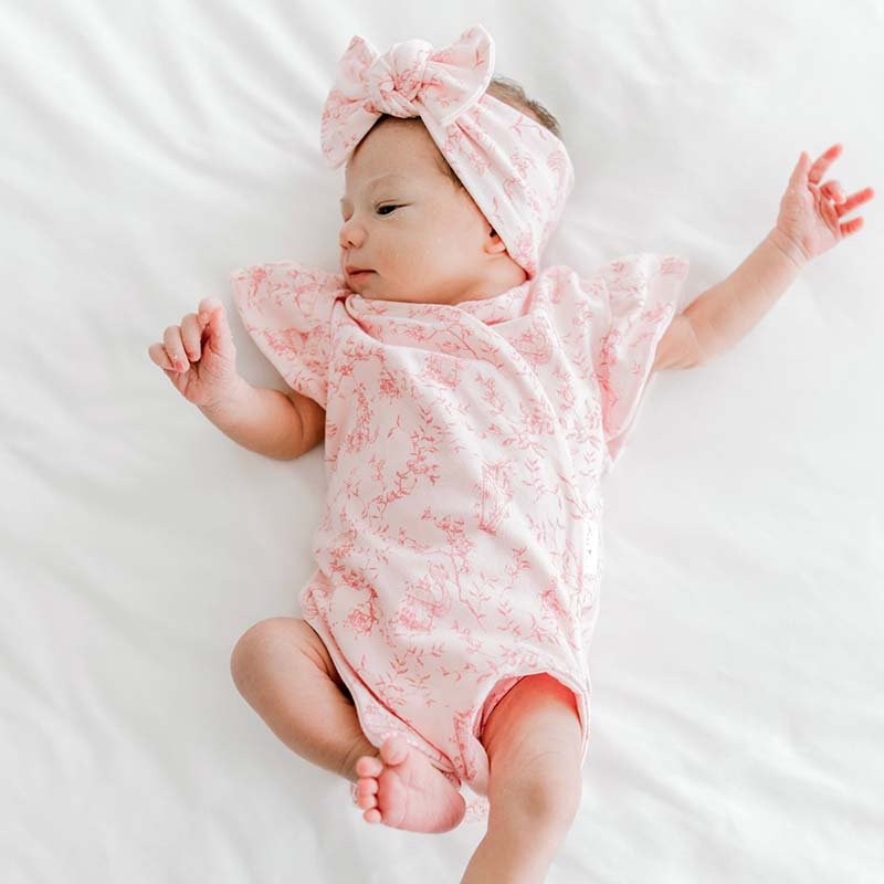 Flutter sleeve winged bodysuit outfit for babies in whimsical garden design.