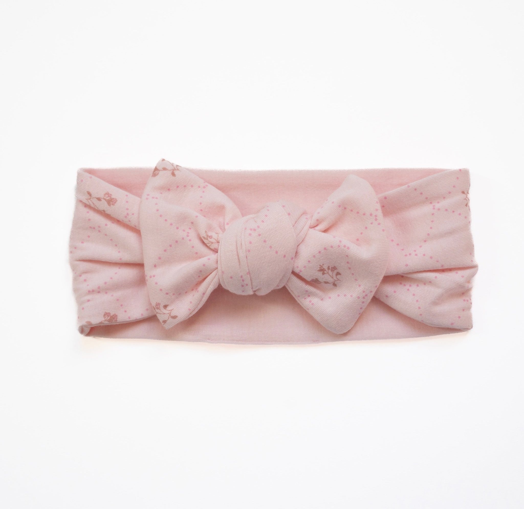 Adorable baby headwrap with bow, made from a bamboo and organic cotton blend in dainty dots.