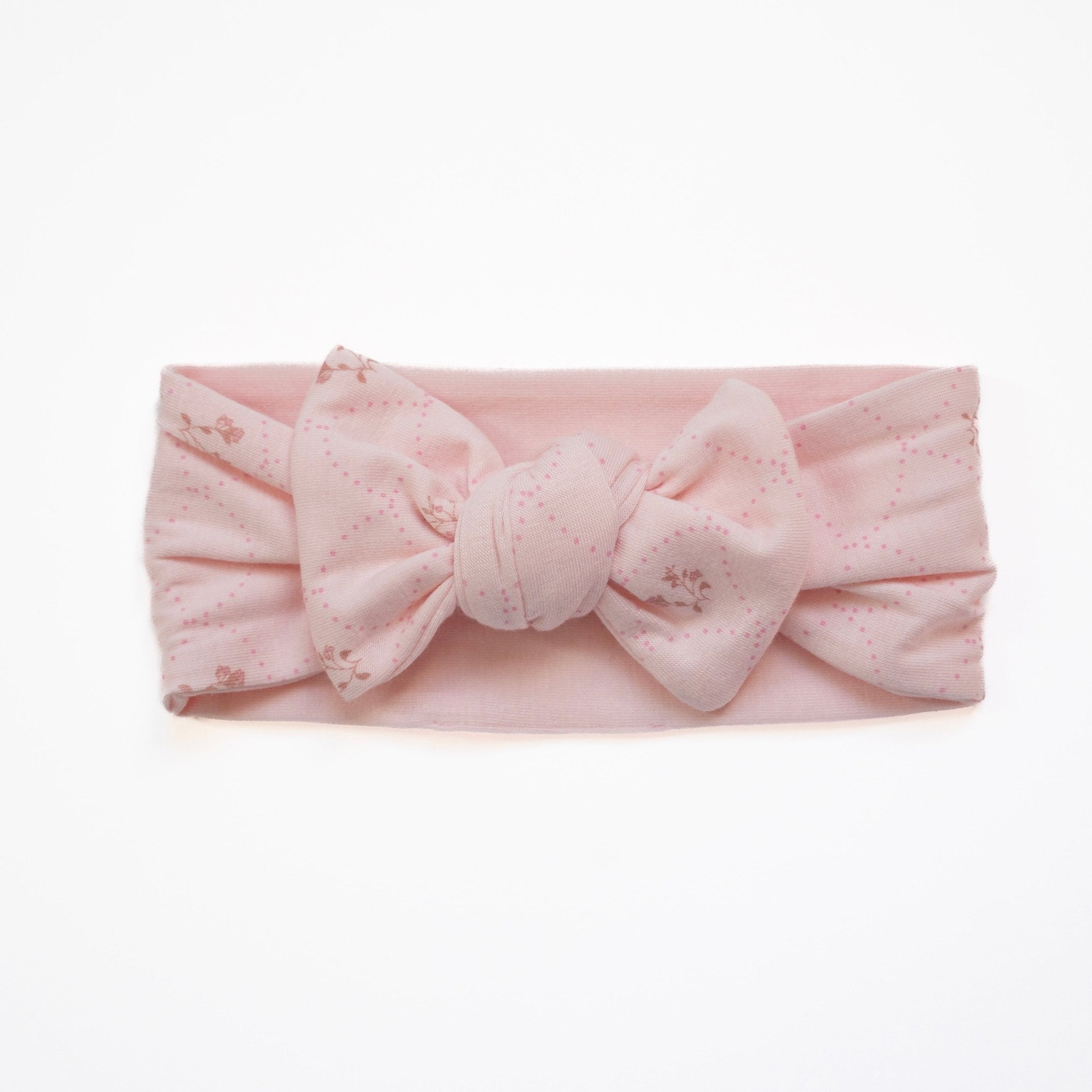 Adorable baby headwrap with bow, made from a bamboo and organic cotton blend in dainty dots.
