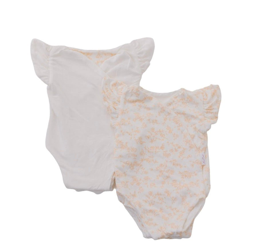 Reversible flutter sleeve baby onesie in bitty blooms design.