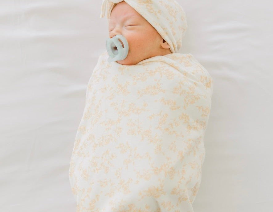 Silk modal newborn essentials bundle featuring a long sleeve top with ruffle cuffs, in bitty blooms design.