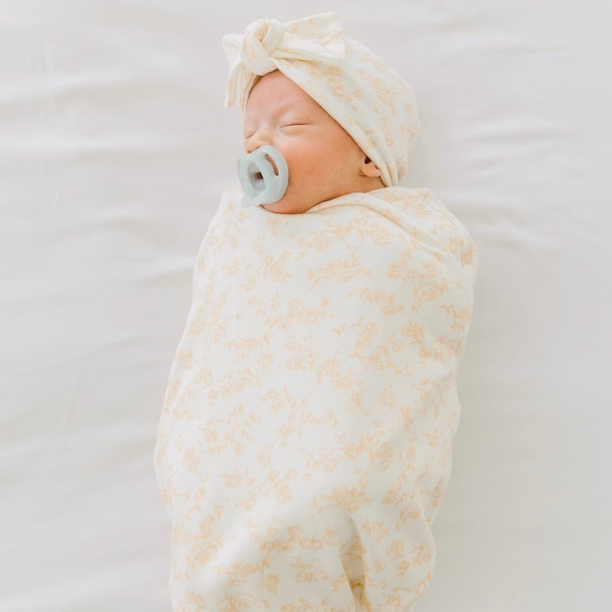 Silk modal newborn essentials bundle featuring a long sleeve top with ruffle cuffs, in bitty blooms design.