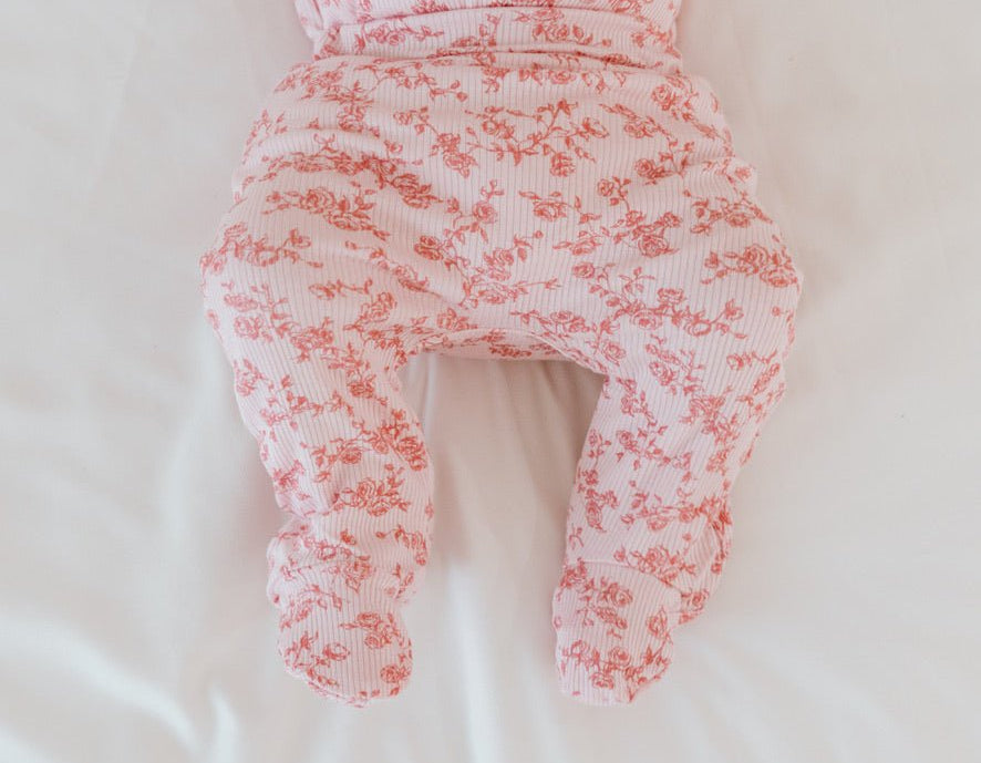Bitty Pink Blooms baby footie pants made with breathable bamboo organic cotton fabric.