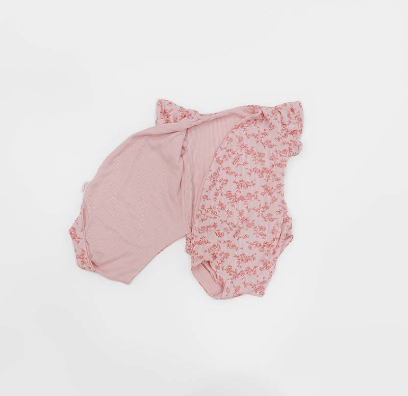 Reversible Bitty Pink Blooms design flutter sleeve winged bodysuit in silky modal fabric.