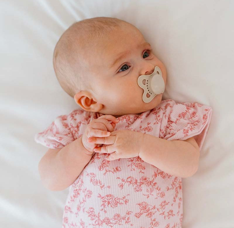 Bitty Pink Blooms design flutter sleeve baby onesie in silky modal fabric.