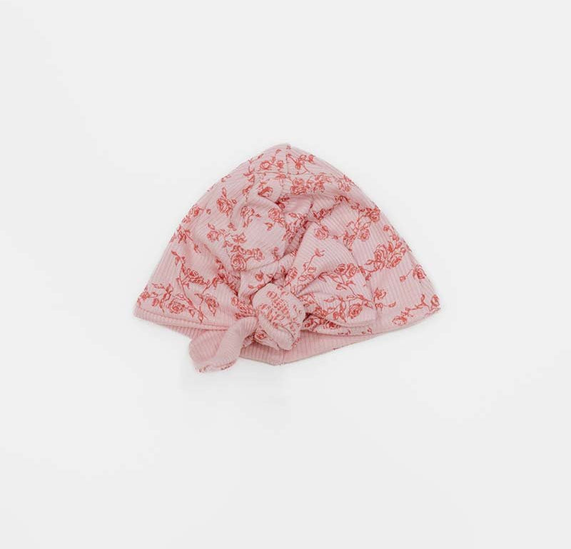 Charming ruched baby beanie with decorative bow in Bitty Pink Blooms styles.