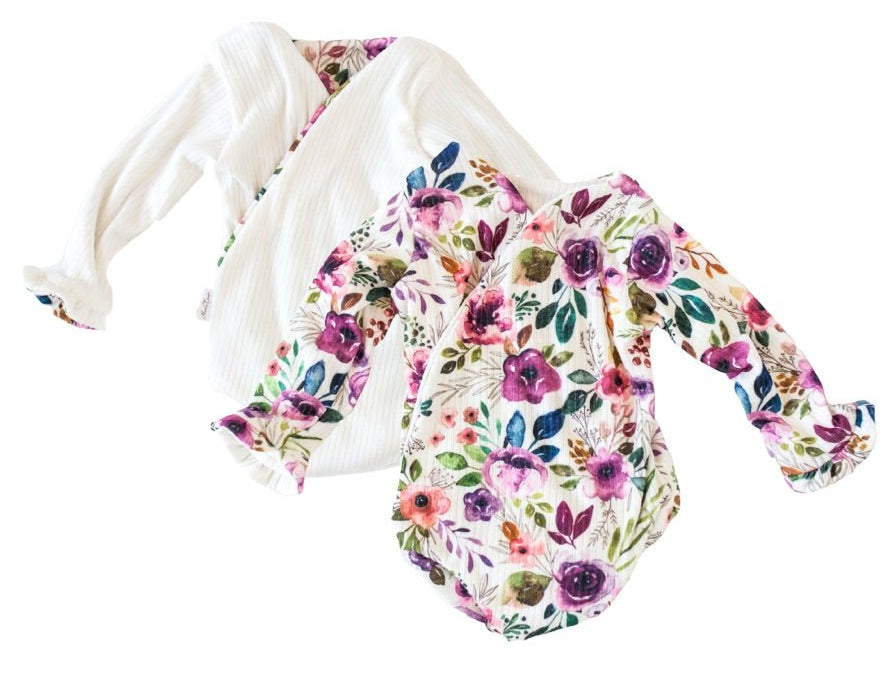 Reversible blushing eucalyptus long sleeve ruffle cuff baby onesie.