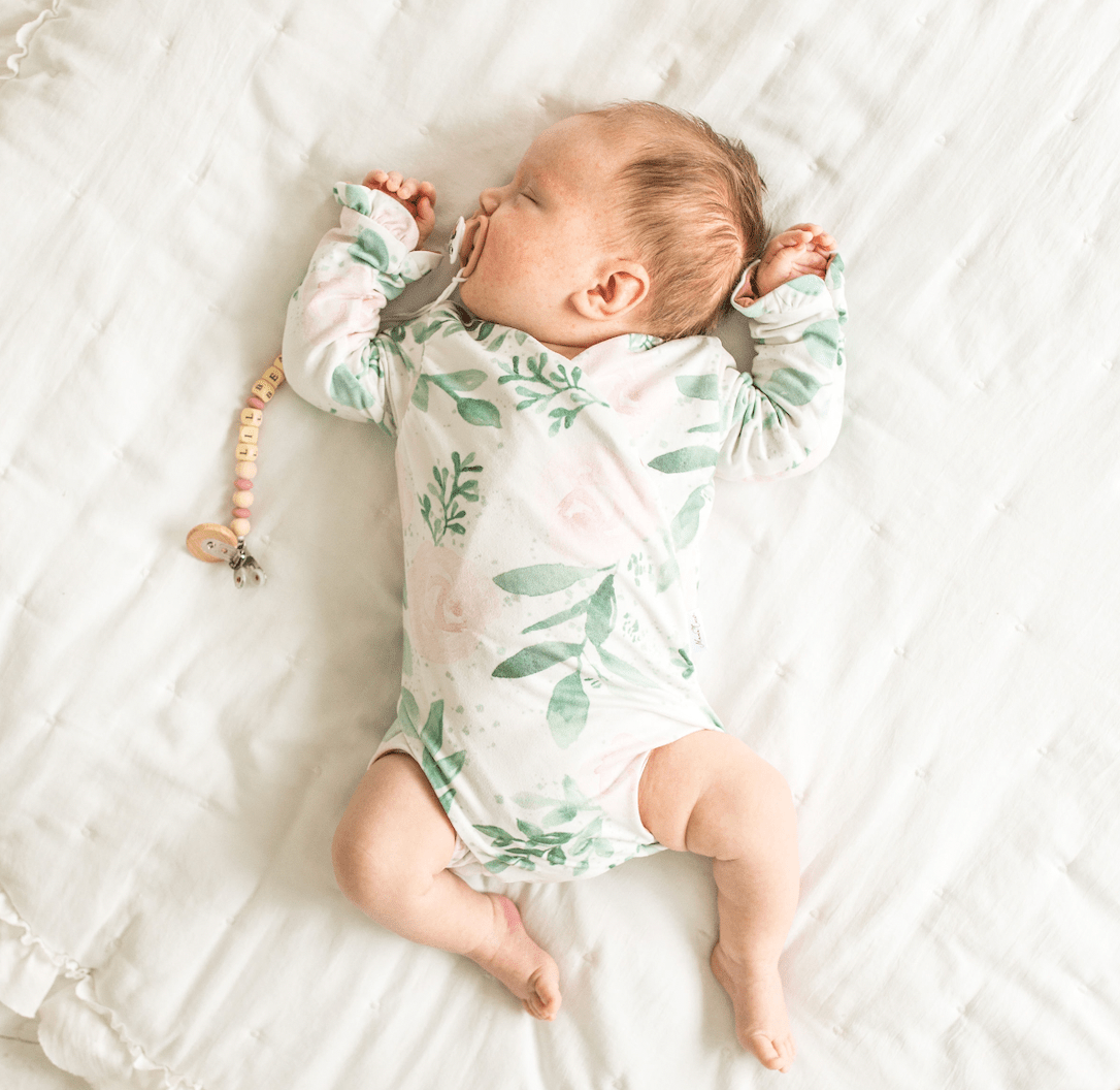 Blushing eucalyptus design ruffle cuff long sleeve onesie.