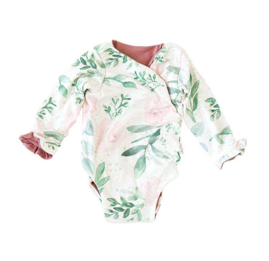 Stylish winged baby bodysuit with ruffle cuffs in soft Blushing Eucalyptus design classic brushed fabric.