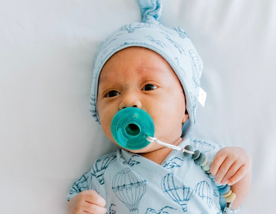 Reversible bamboo cotton baby beanie in bon voyage design.