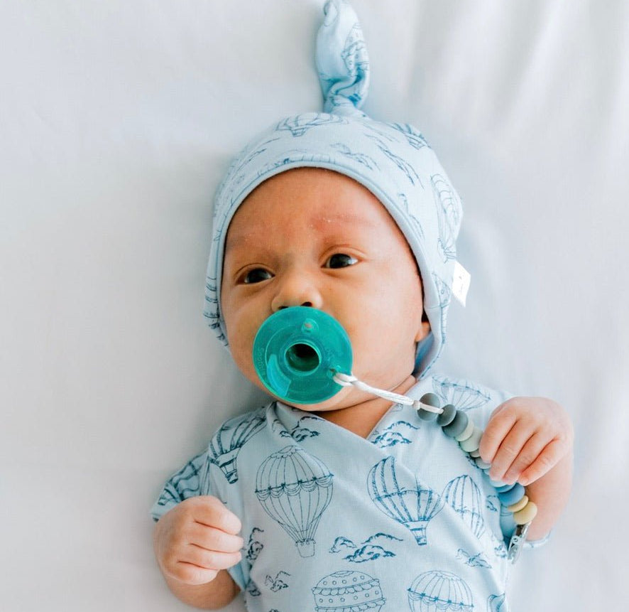 Reversible bamboo cotton baby beanie in bon voyage design.
