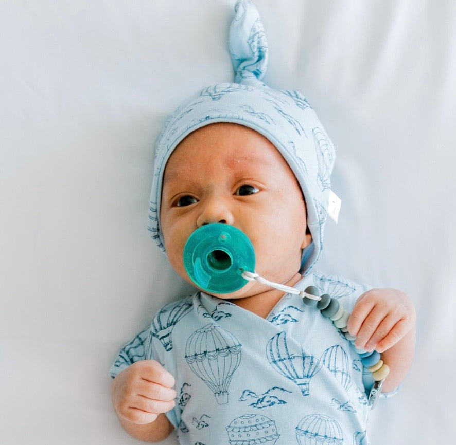 Reversible bamboo cotton baby beanie in bon voyage design.